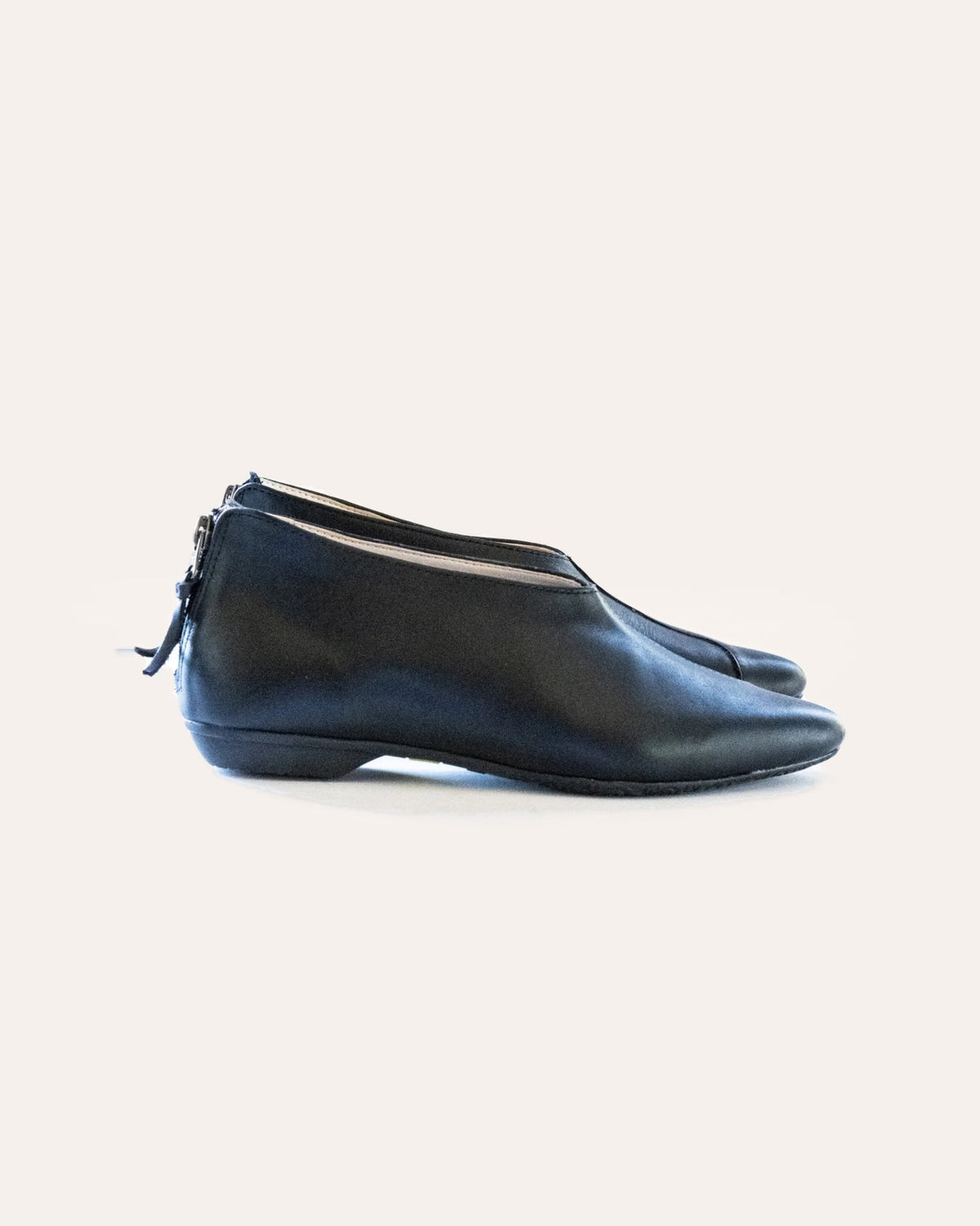 Pixie Flat – black leather slip-on flat with a back zip, side view, handmade by Phelan
