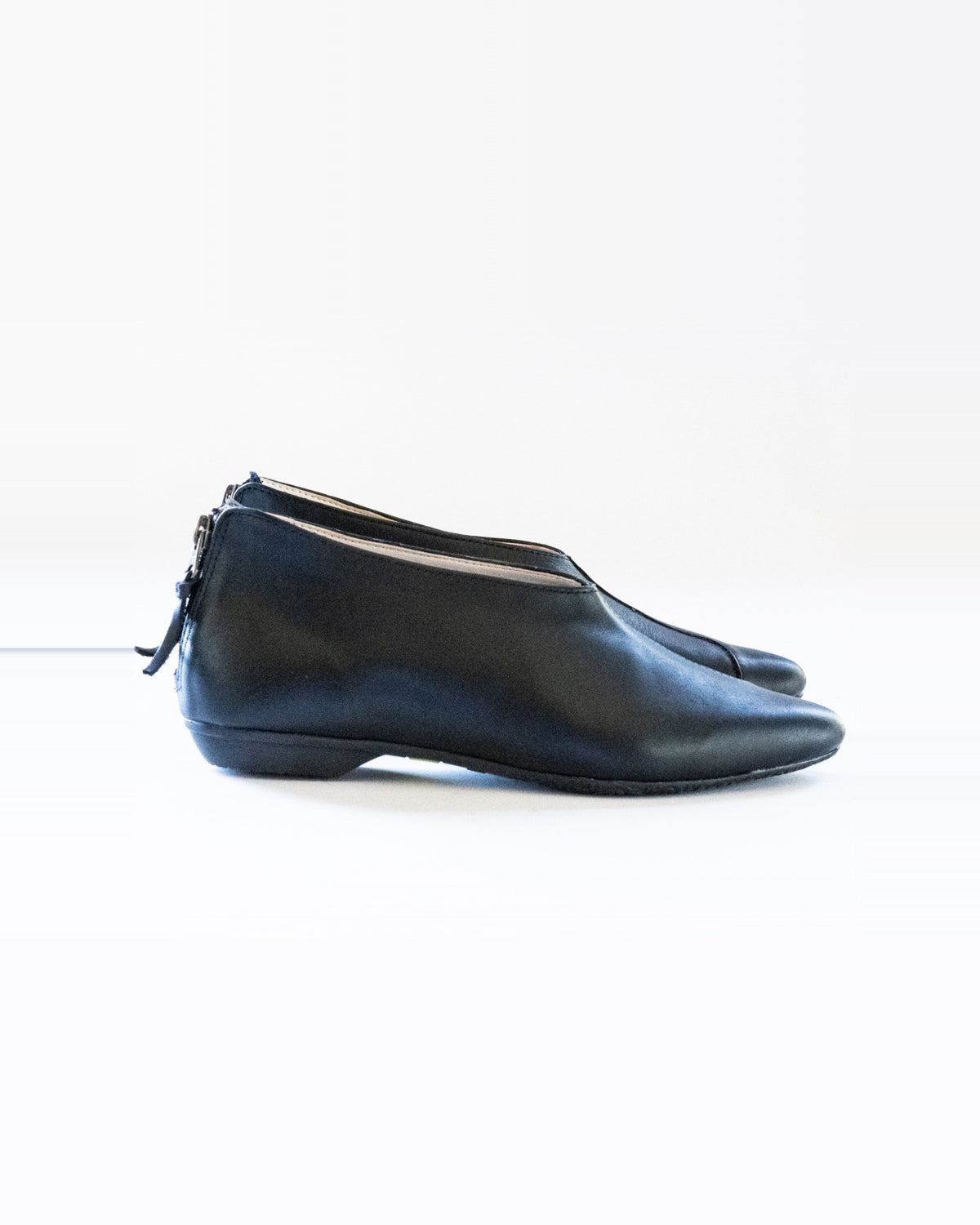 Black Zoo Flats – black leather slip-on flat with a back zip, side view, handmade by Phelan