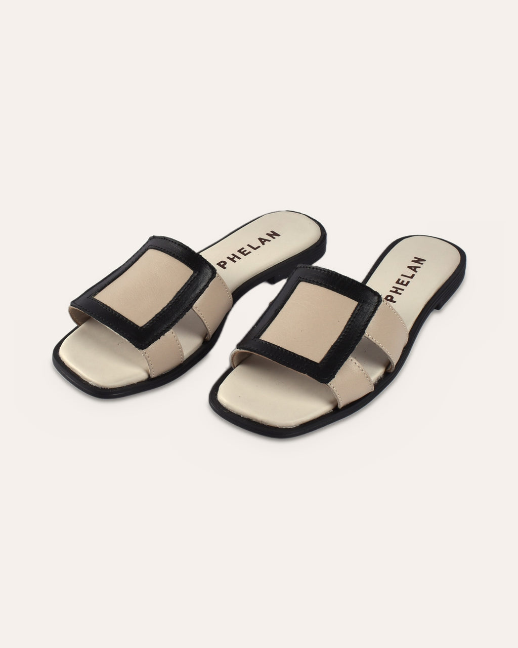Coco Slide in Mink/Black leather, pair from the front three-quarter