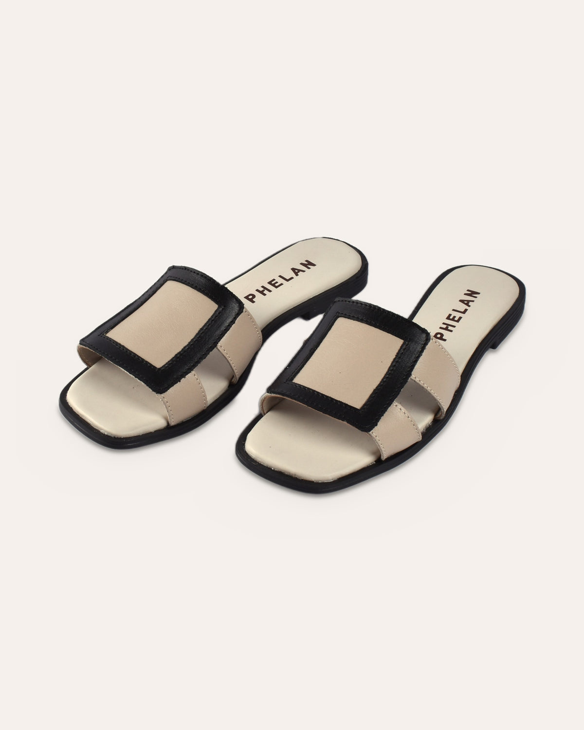 Coco Slide in Mink/Black leather, pair from the front three-quarter