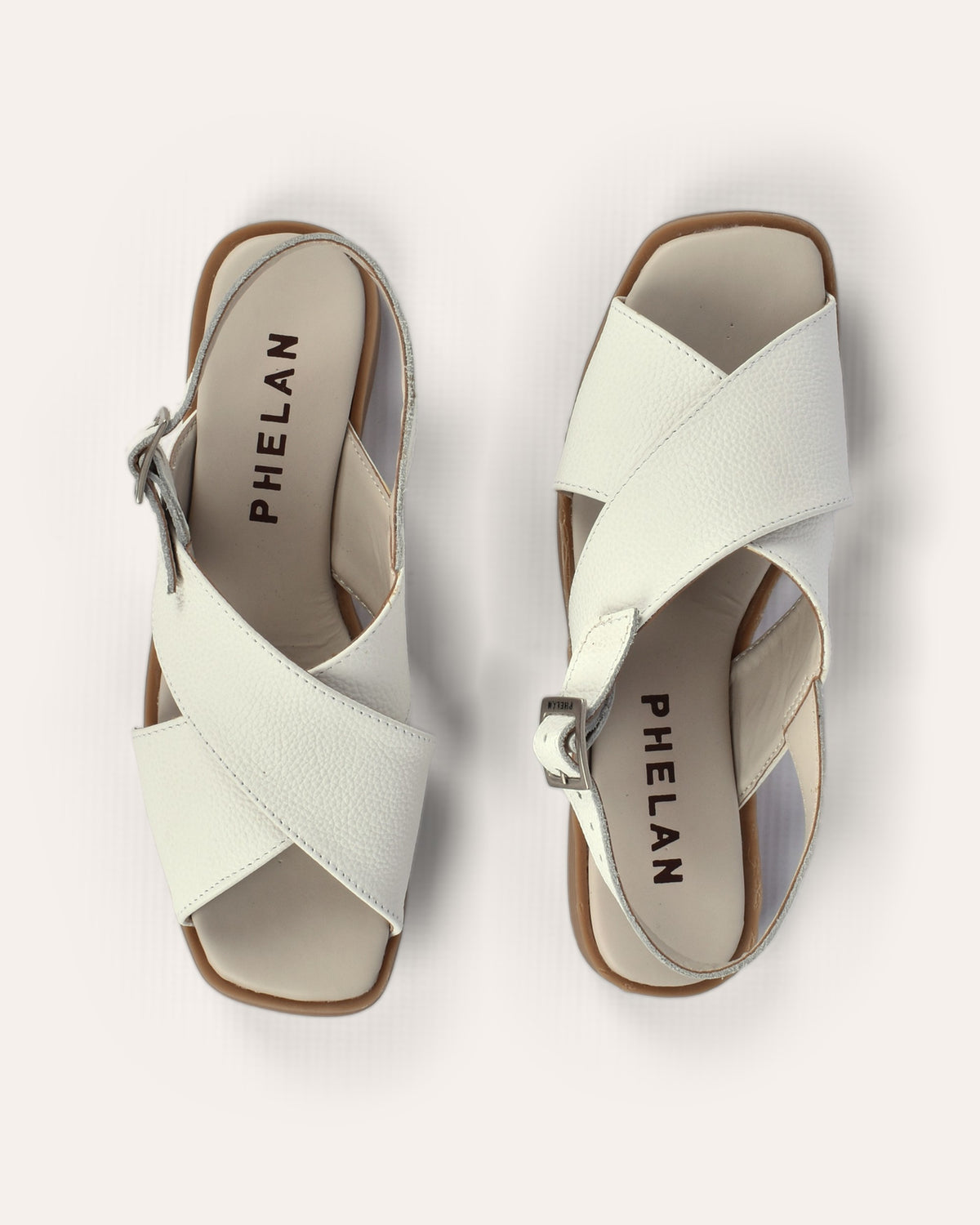 Capri Sandal in White from above, showing the crossover straps and PHELAN footbed