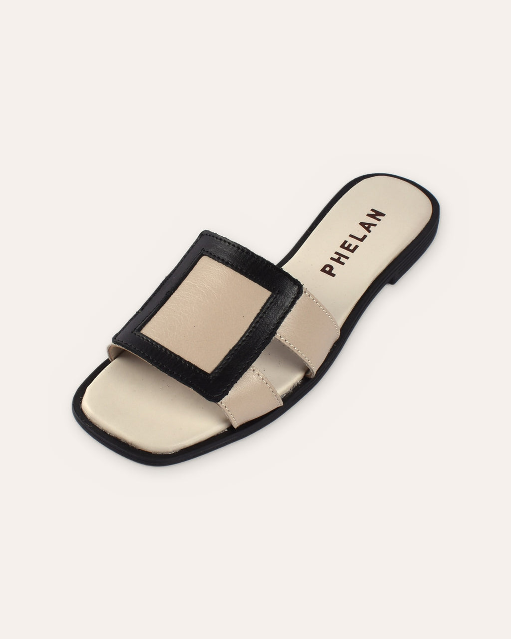Coco Slide in Mink/Black leather, close three-quarter view of the square frame