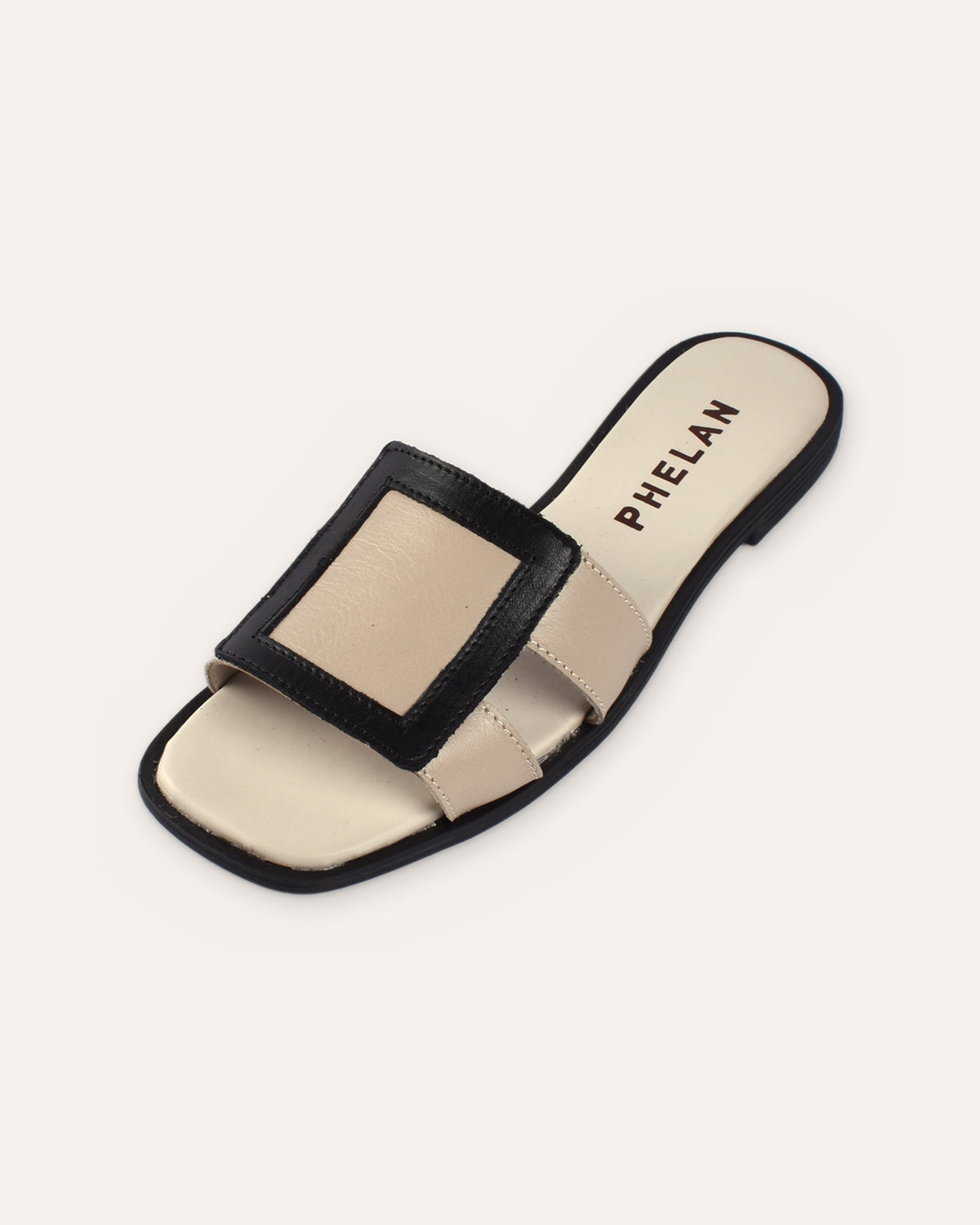 Coco Slide in Mink/Black leather, close three-quarter view of the square frame