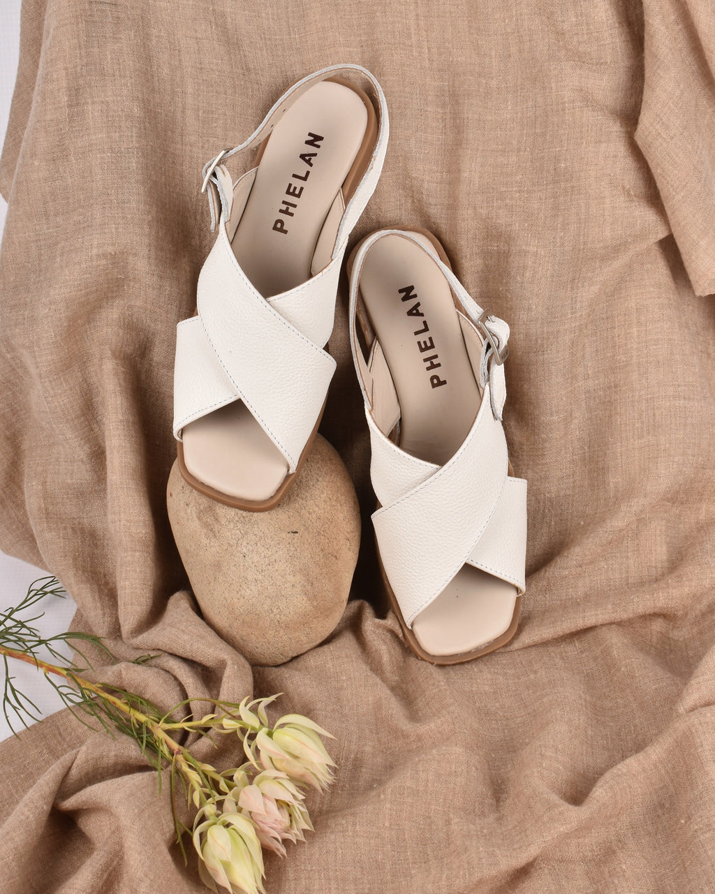 Capri Sandal in White, styled with protea — handmade leather sandal by Phelan Footwear