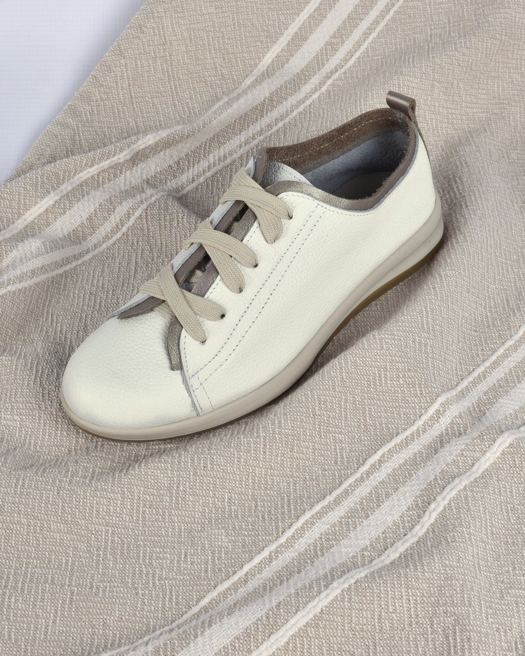 Hydra Sneaker in White/Pewter on an oatmeal striped throw