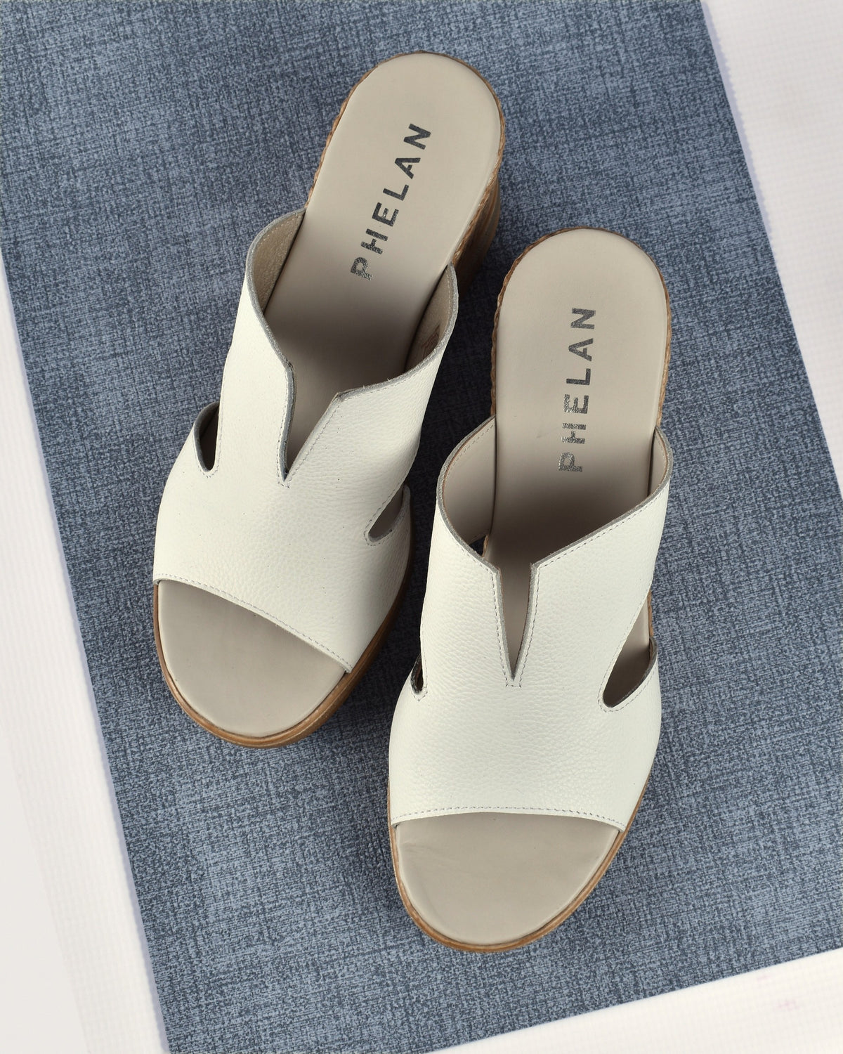 Positano Wedge in White on a blue linen mat, from above
