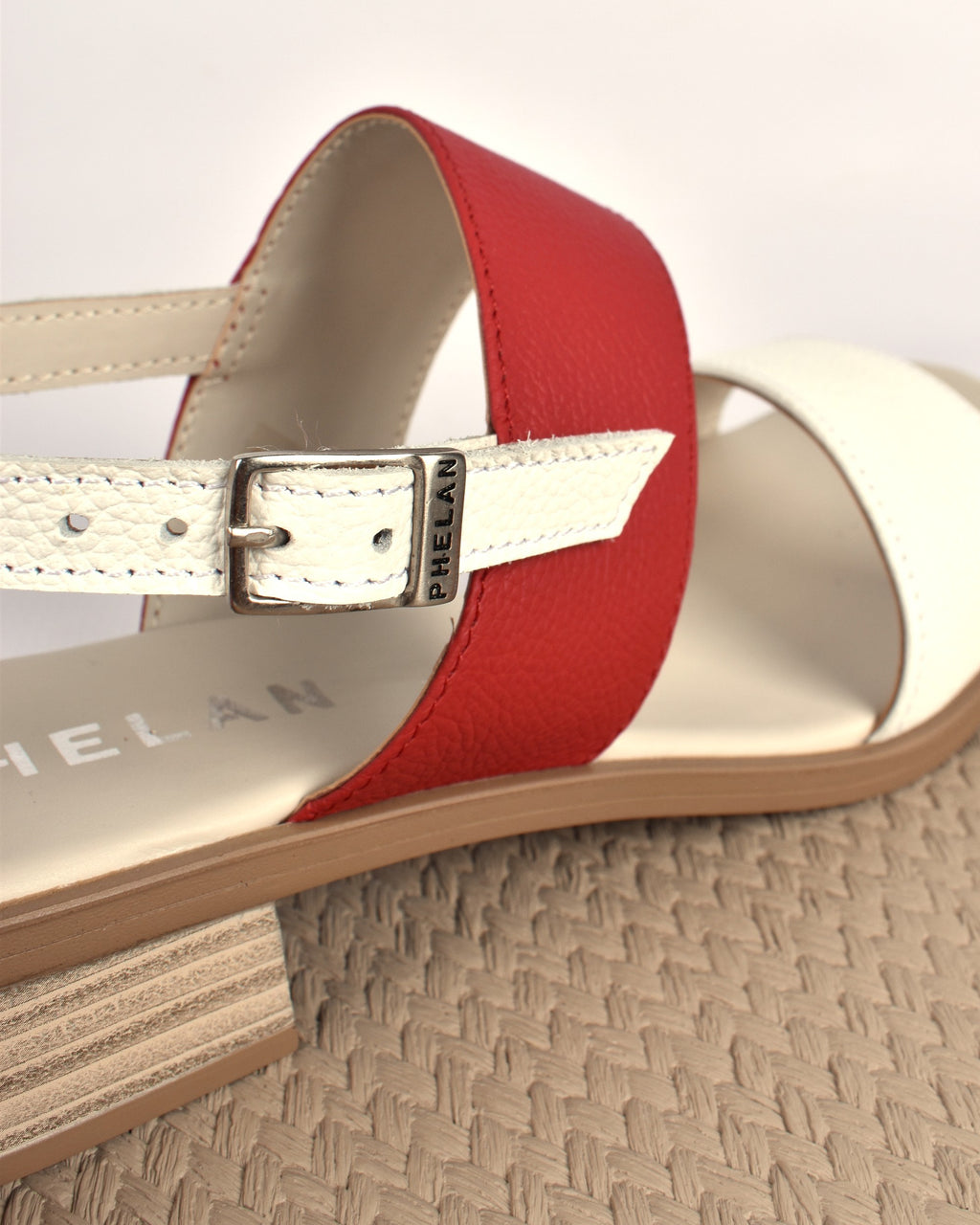 Portofino Heel in White/Red, close-up of the buckled heel strap