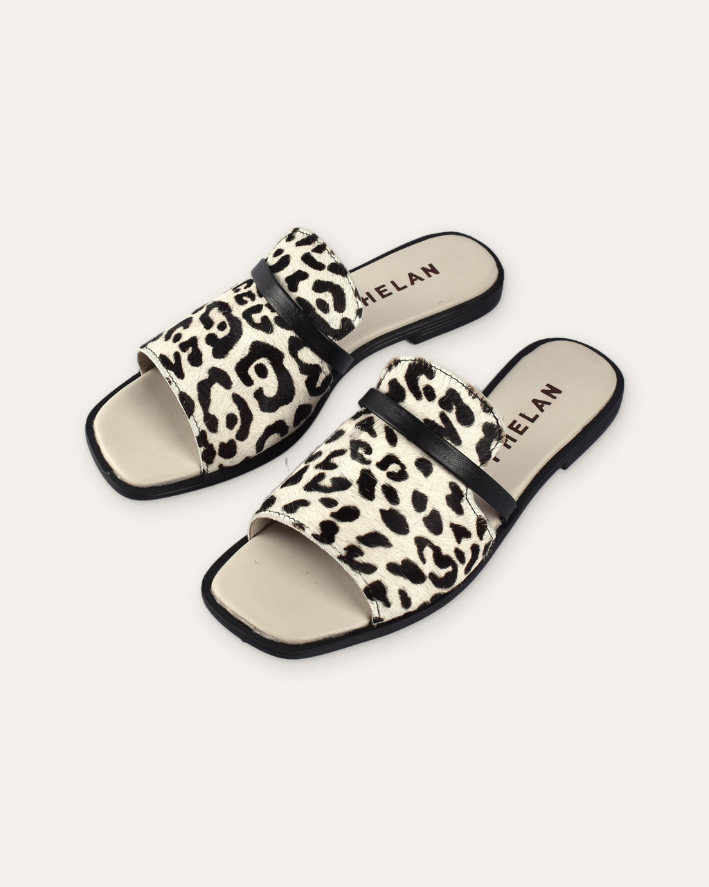 Sabi Slide in Snow Leopard/Black — handmade hair-on leather slide by Phelan Footwear