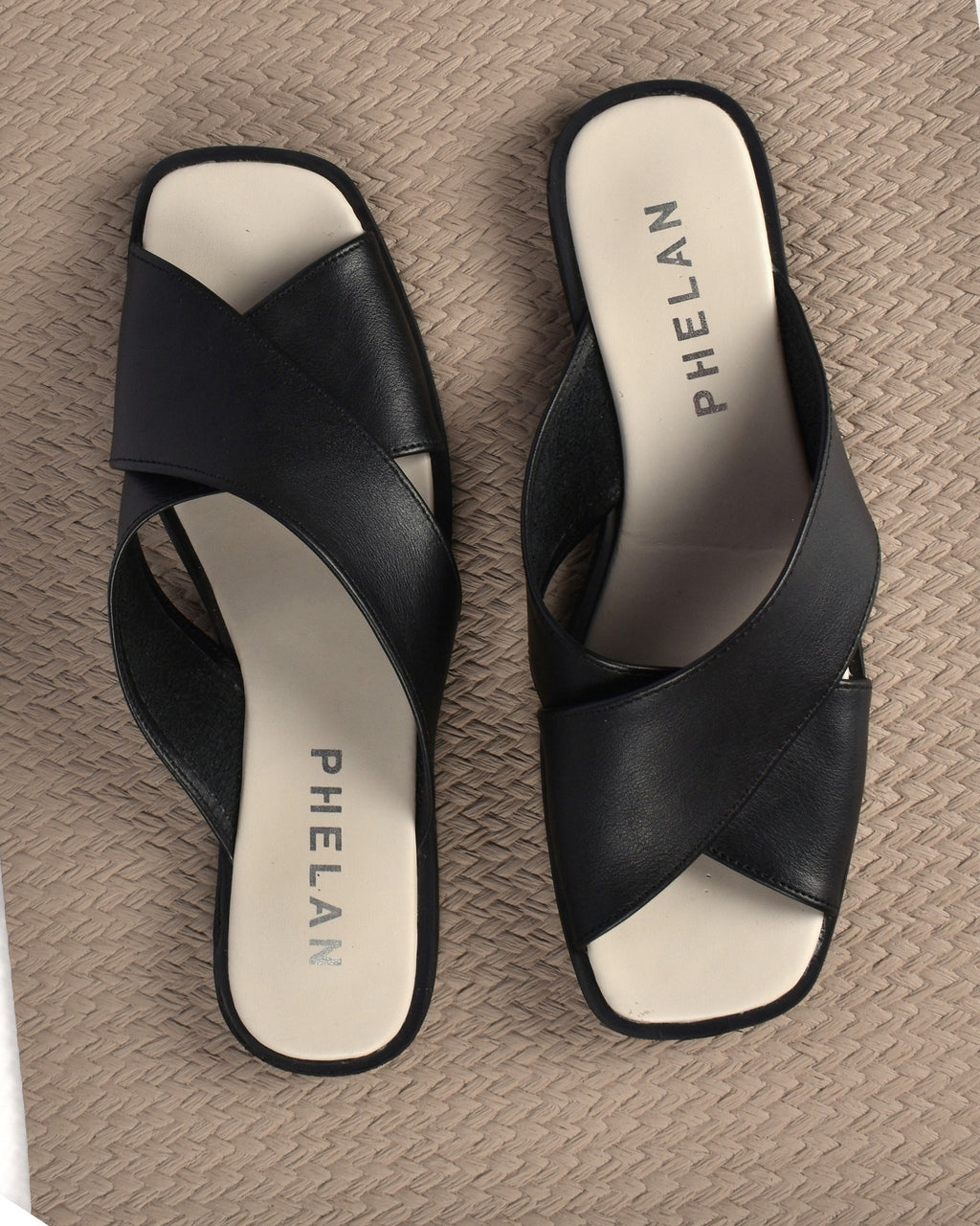 Elba Slide in Black, the pair from above on a taupe mat