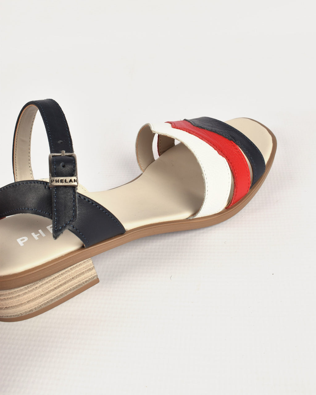 Corfu Heel in Navy/Red/White, close-up of the ankle strap and PHELAN buckle