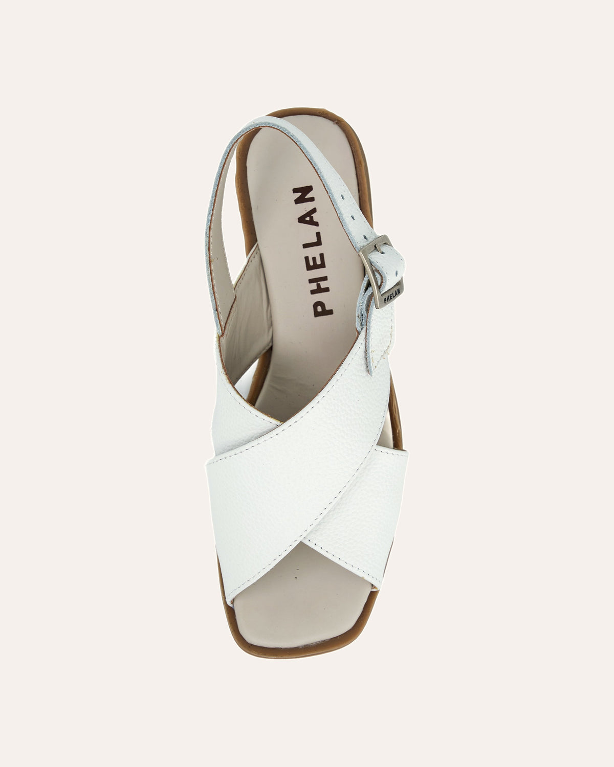 Capri Sandal in White from above, showing the crossover straps, buckle and PHELAN footbed