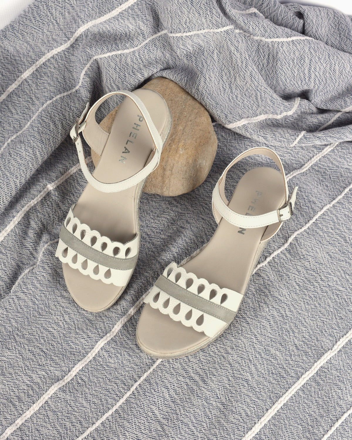 Dolly Wedge in White/Grey, the pair on a blue-grey throw