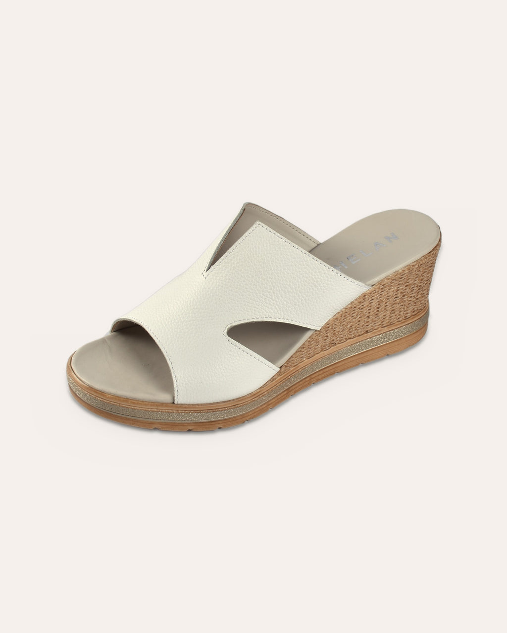 Positano Wedge in White, single shoe showing the V-notch and side cut-outs