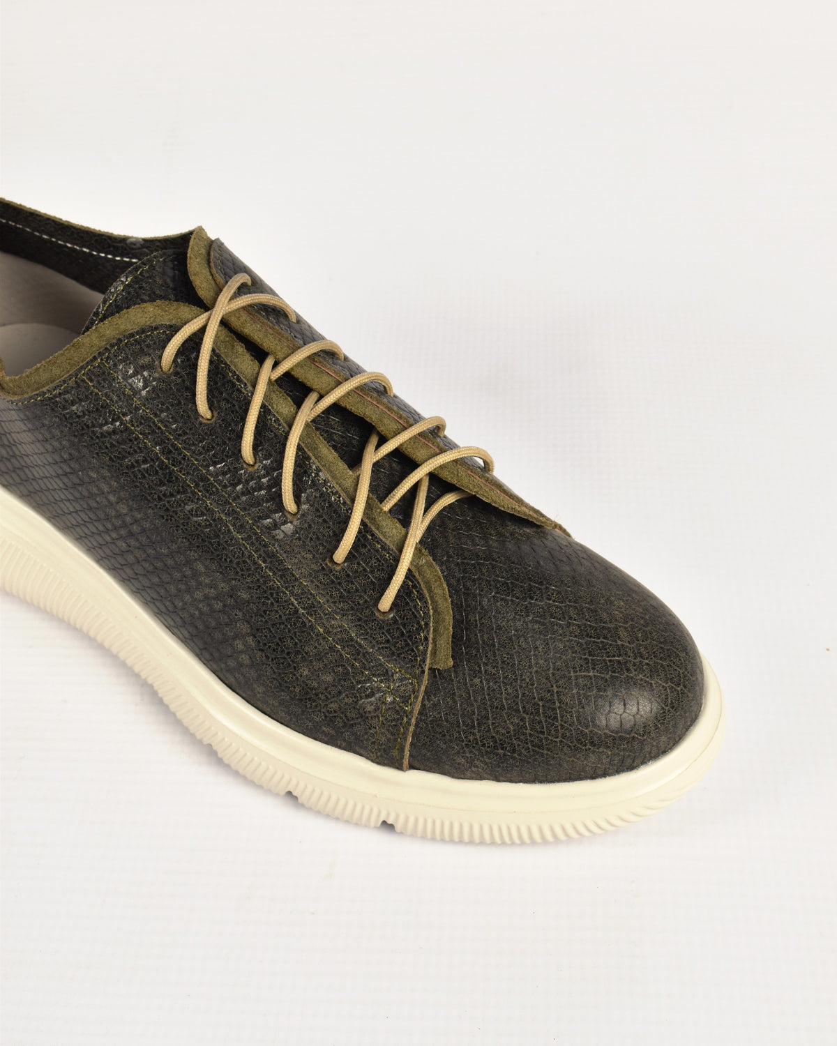 Deck Sneaker in Olive/Olive, close-up of the laces and snake-embossed leather