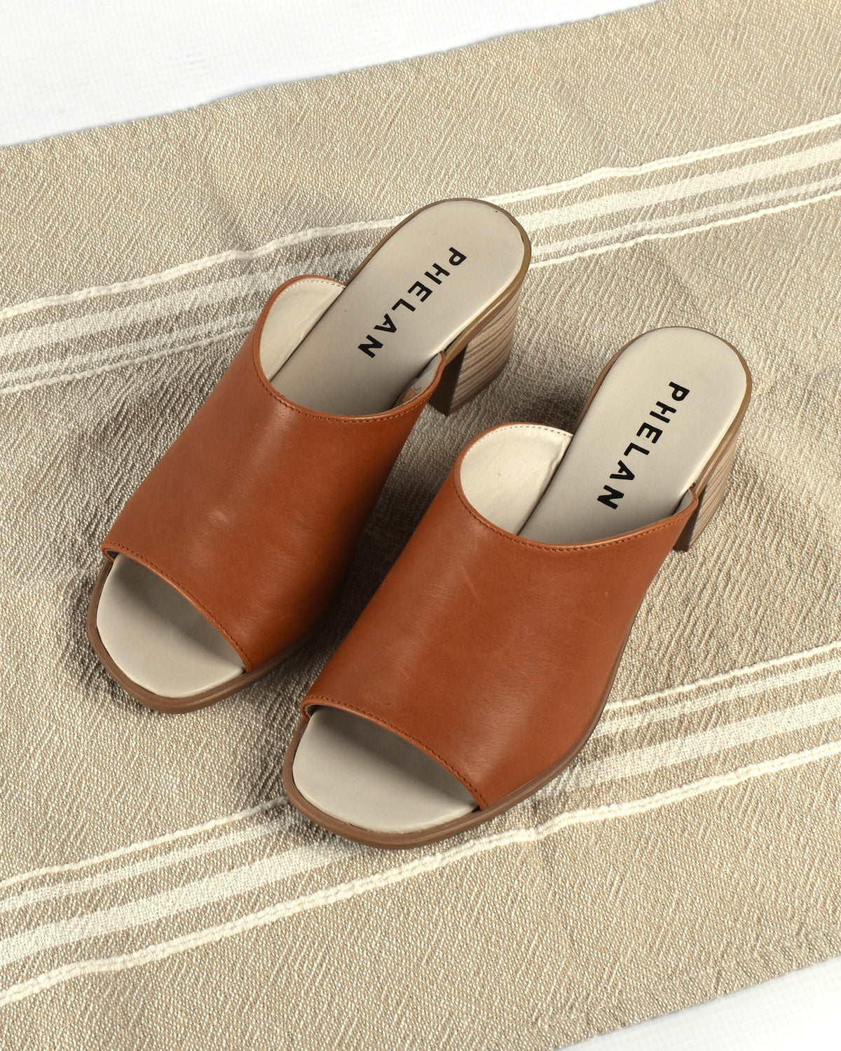 Sorrento Heel in Tan, the pair on a striped linen throw