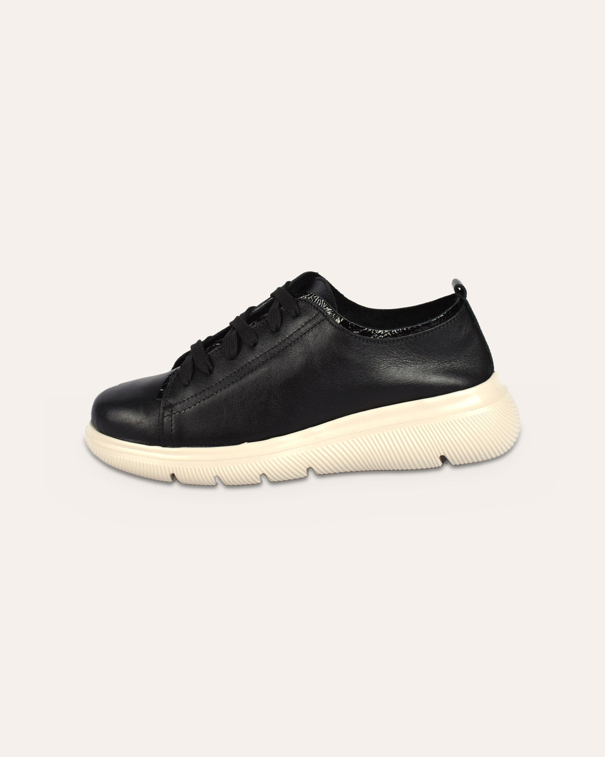 Deck Sneaker in Black, side view of the chunky cream sole