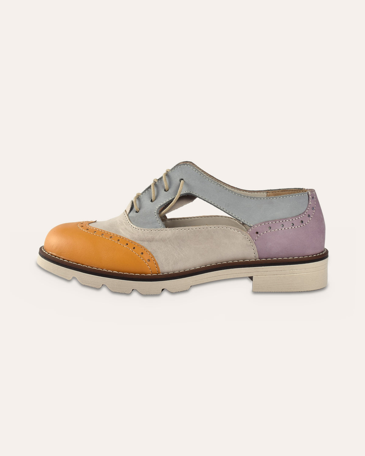 Darcy Brogue side view showing the cut-out sides and cream lugged rubber sole