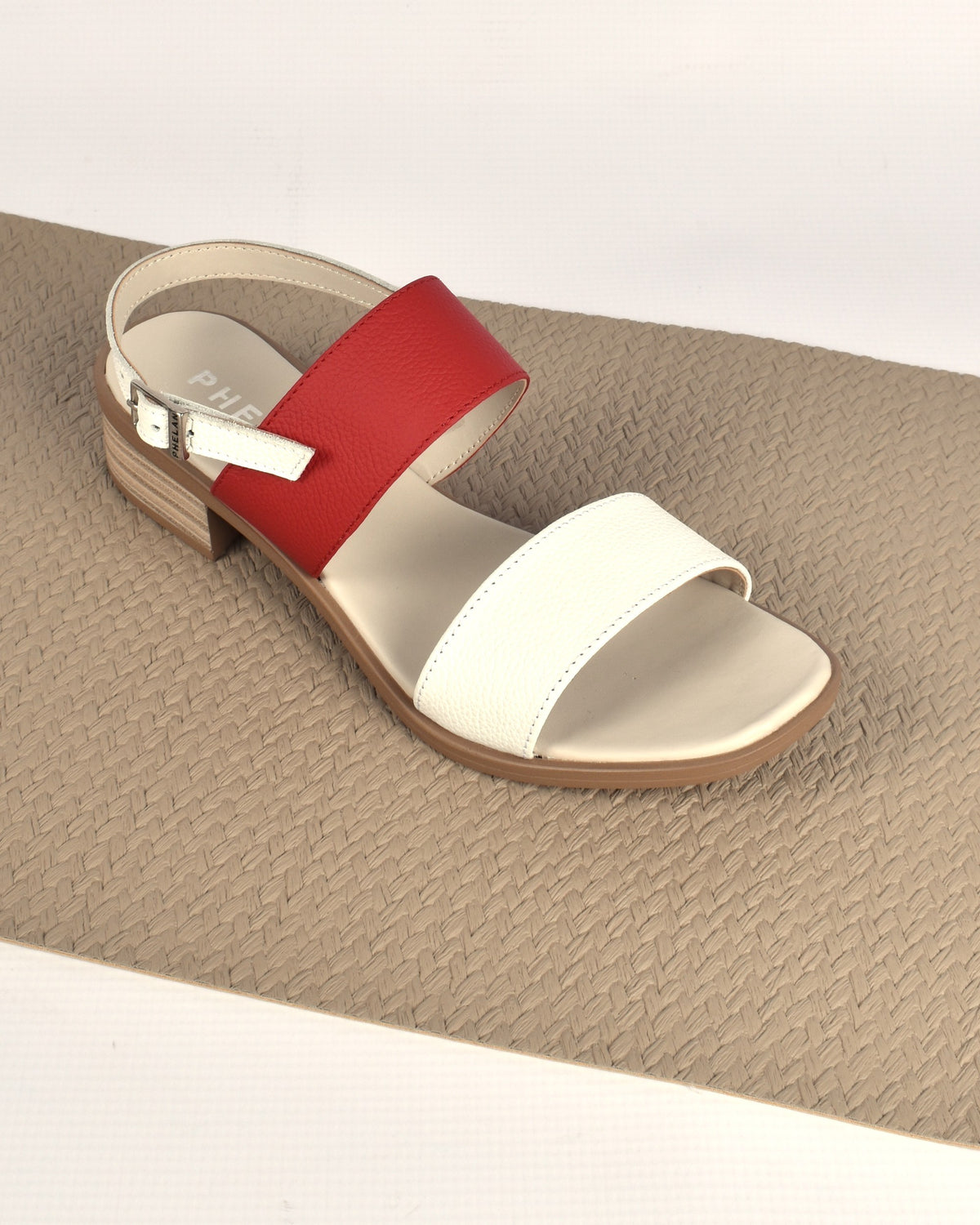 Portofino Heel in White/Red on a woven taupe mat