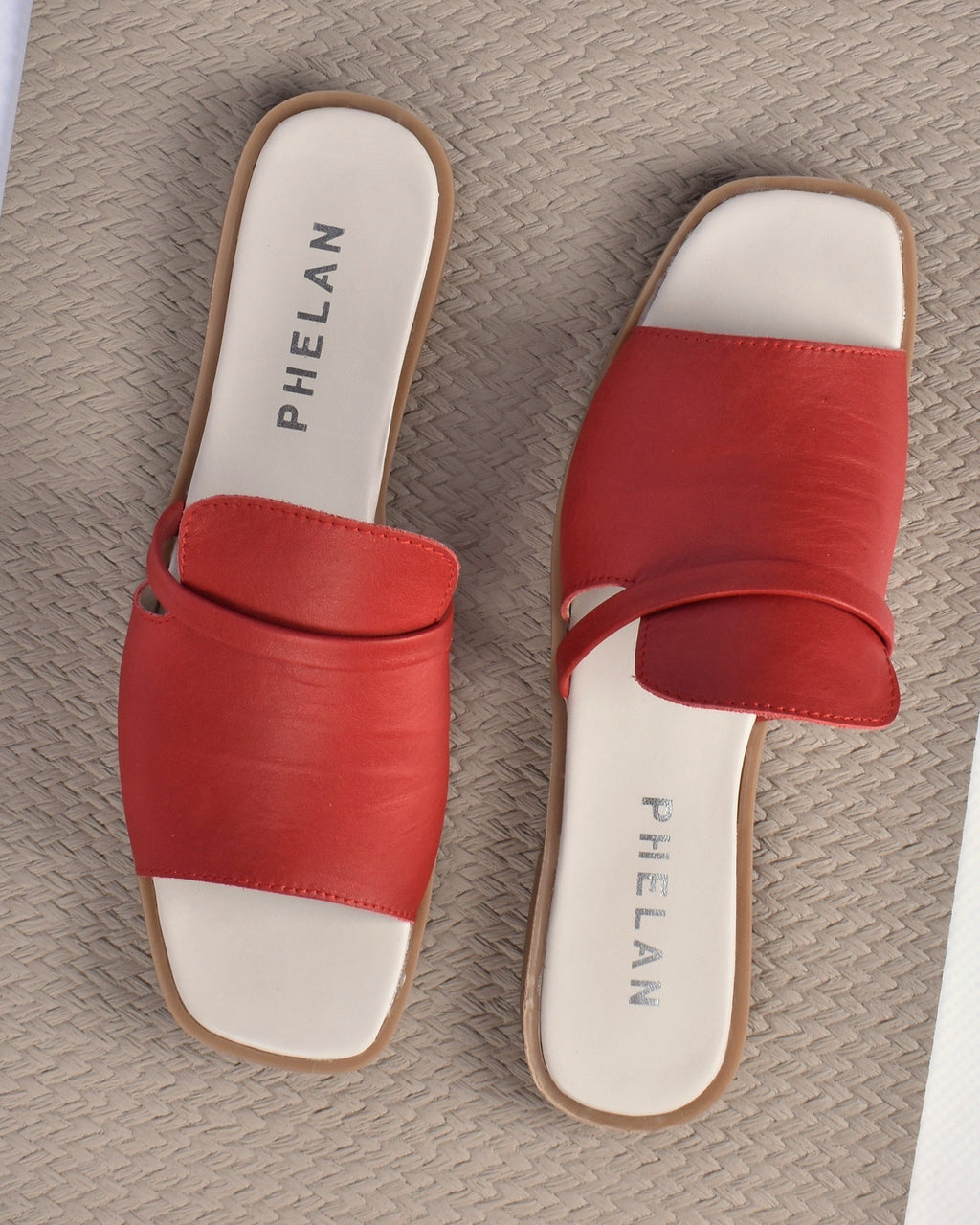 Ravello Slide in Red, the pair from above on a woven mat