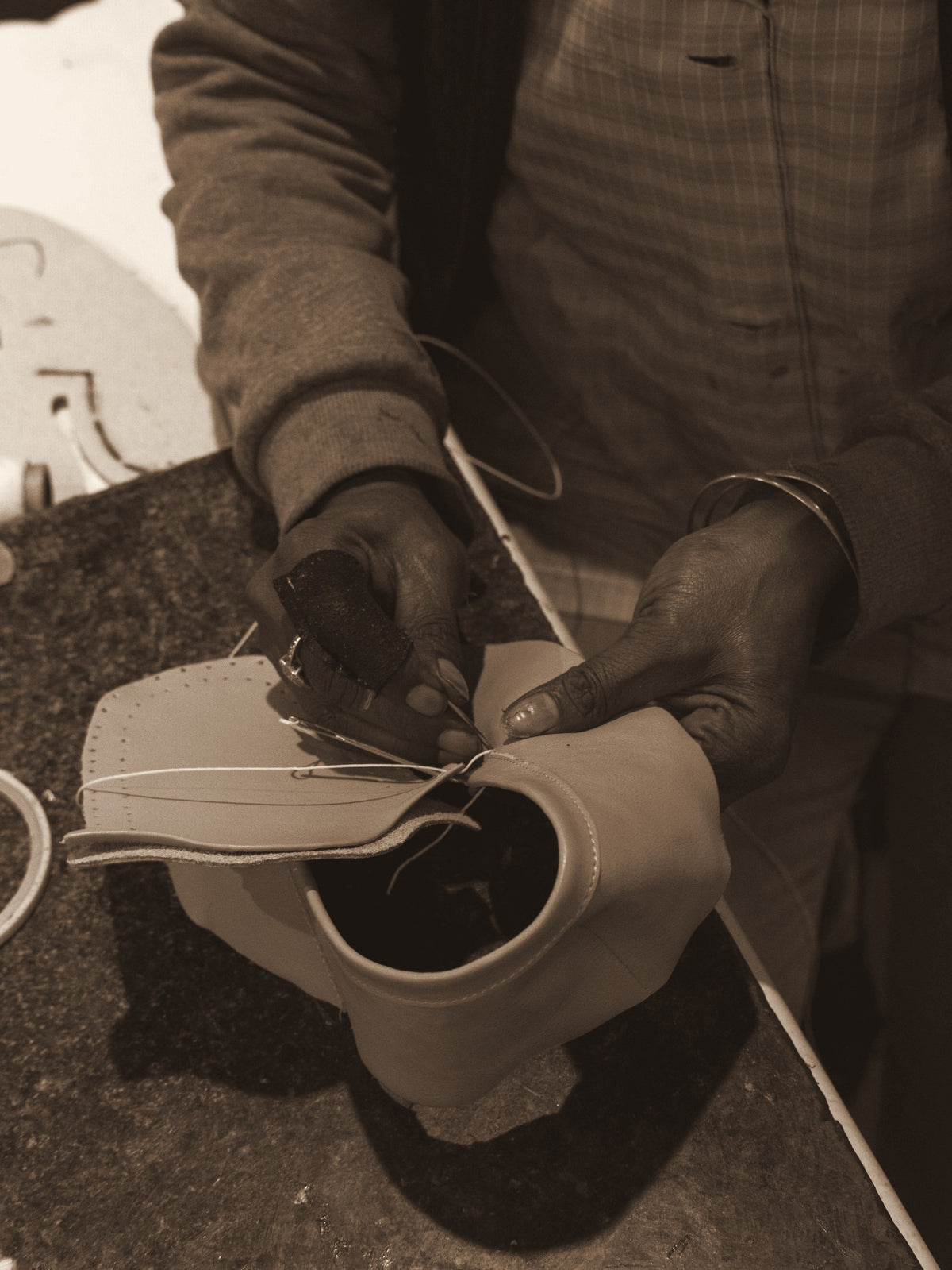 Hand stitching an upper in the Phelan factory, Somerset West
